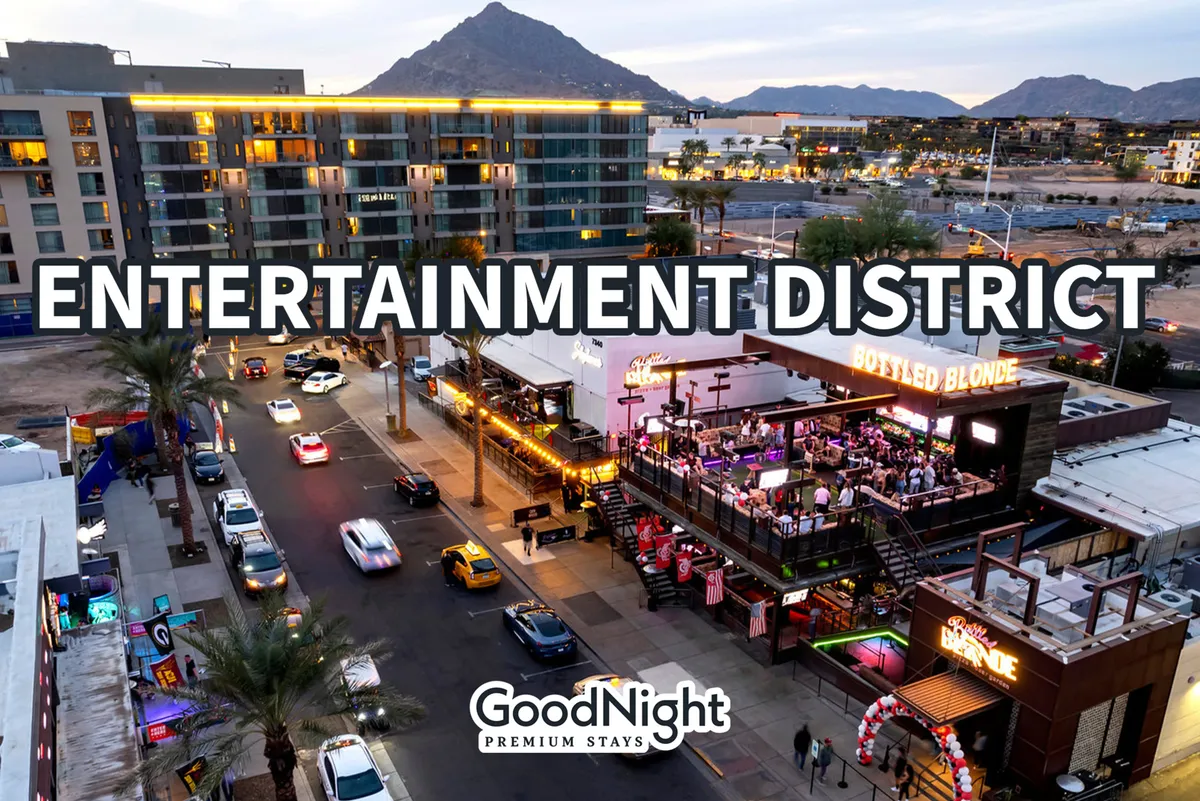 A lively nighttime scene in the heart of Scottsdale's entertainment district, featuring Bottled Blonde, bright signage, a bustling street with cars, and a lively crowd. The mountain backdrop hints at the city’s unique desert setting, and the energy of people enjoying local nightlife and dining is palpable.